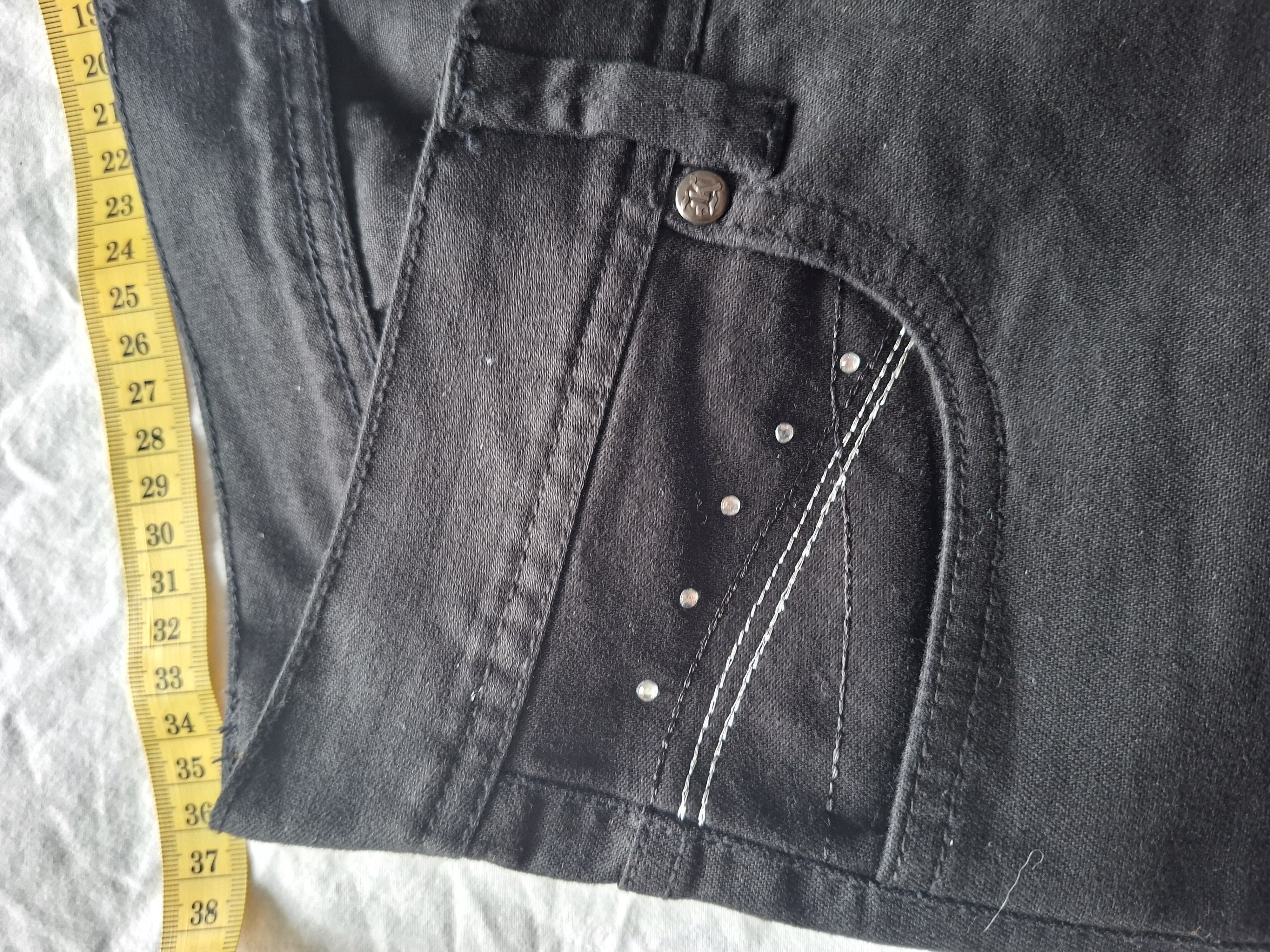 Zwarte flared broek met strass details en witte stiksels