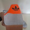 Adidas Gazelle sneakers lichtblauw met zwarte strepen en oranje hielstuk